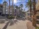 Beautiful community building surrounded by lush landscaping, a pool, picnic tables, and palm trees at 7111 S Durango Dr # 305, Las Vegas, NV 89113