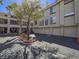 Exterior of building with garage parking, a well-maintained landscape, and mature trees at 7111 S Durango Dr # 305, Las Vegas, NV 89113