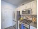 Well-lit kitchen featuring stainless steel appliances, updated cabinets, and modern tile backsplash at 7111 S Durango Dr # 305, Las Vegas, NV 89113