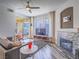 Bright living room featuring a ceiling fan, modern fireplace, and balcony access at 7111 S Durango Dr # 305, Las Vegas, NV 89113