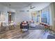 Inviting living room with modern ceiling fan, dining area, and balcony access at 7111 S Durango Dr # 305, Las Vegas, NV 89113