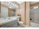 Bathroom featuring a single sink vanity, large mirror, and shower-tub combo at 8452 Boseck Dr # 110, Las Vegas, NV 89145