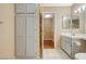 Bathroom featuring tile floors, a built-in linen closet, and a vanity sink at 8452 Boseck Dr # 110, Las Vegas, NV 89145