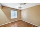 Bedroom with wood floors, neutral paint, and a window for natural light at 8452 Boseck Dr # 110, Las Vegas, NV 89145