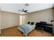 Comfortable bedroom with wood floors, ceiling fan, and piano at 8452 Boseck Dr # 110, Las Vegas, NV 89145