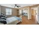 Bedroom featuring a ceiling fan, closet with mirrored doors, and wood-look flooring at 8452 Boseck Dr # 110, Las Vegas, NV 89145