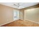 Cozy bedroom featuring a ceiling fan, wood floors, and natural light from the french doors at 8452 Boseck Dr # 110, Las Vegas, NV 89145
