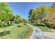 Well-manicured community lawn with walking paths and mature trees at 8452 Boseck Dr # 110, Las Vegas, NV 89145