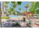 Community pool with pergola and lush landscaping at 8452 Boseck Dr # 110, Las Vegas, NV 89145