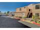 Exterior view of a condo complex with parking, landscaping, and stairs to units at 8452 Boseck Dr # 110, Las Vegas, NV 89145