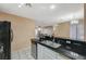 Open kitchen featuring a stainless steel sink and breakfast bar seating at 8452 Boseck Dr # 110, Las Vegas, NV 89145