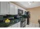 Well-lit kitchen featuring modern appliances with white cabinets at 8452 Boseck Dr # 110, Las Vegas, NV 89145
