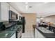 Kitchen area featuring modern appliances with access to the living area at 8452 Boseck Dr # 110, Las Vegas, NV 89145