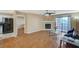 Bright living room with fireplace, wood floors, and access to the patio at 8452 Boseck Dr # 110, Las Vegas, NV 89145