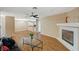 Inviting living room featuring a fireplace, ceiling fan, and wood-look flooring at 8452 Boseck Dr # 110, Las Vegas, NV 89145