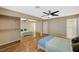 Spacious main bedroom with mirrored closet doors and a ceiling fan at 8452 Boseck Dr # 110, Las Vegas, NV 89145