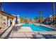Inviting community pool area with lounge chairs, umbrellas, and lush landscaping for residents' enjoyment at 8501 W University Ave # 2020, Las Vegas, NV 89147