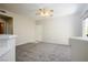 Open floor plan with carpet and view into kitchen area at 8501 W University Ave # 2020, Las Vegas, NV 89147