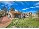 Large backyard featuring a covered patio, lawn area, and a shed for extra storage at 872 Linn Ln, Las Vegas, NV 89110