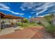 Spacious backyard with a covered patio, seating area, and a mix of grass and gravel at 872 Linn Ln, Las Vegas, NV 89110