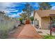 Side yard featuring gravel area, block wall, shed, and access gate, offering utility and privacy at 872 Linn Ln, Las Vegas, NV 89110