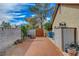 Side yard featuring gravel, block wall, shed, and a storage area, providing space for projects at 872 Linn Ln, Las Vegas, NV 89110