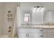 Bright bathroom with a double sink vanity, framed mirrors, and a shower-tub combination at 872 Linn Ln, Las Vegas, NV 89110