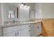 Bright bathroom with a double sink vanity, framed mirrors, and modern light fixtures at 872 Linn Ln, Las Vegas, NV 89110