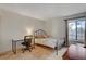 Comfortable bedroom with a desk, a large window, and neutral tile flooring at 872 Linn Ln, Las Vegas, NV 89110