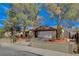 Charming home with a spacious driveway, two-car garage, and beautiful landscaping, all under a sunny sky at 872 Linn Ln, Las Vegas, NV 89110