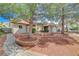 Charming single-story home featuring mature trees, brick accents, and a welcoming walkway at 872 Linn Ln, Las Vegas, NV 89110