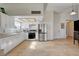 Well-lit kitchen features white cabinets and stainless steel appliances at 872 Linn Ln, Las Vegas, NV 89110