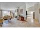 Cozy living room featuring a fireplace, travertine floors, and a view to the kitchen at 872 Linn Ln, Las Vegas, NV 89110