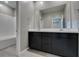 Bathroom boasts dual sinks, white countertops and wood-look tile floors at 9239 Albus Hills Ave, Las Vegas, NV 89143