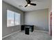 Neutral bedroom features a modern desk, ceiling fan and carpeted floors at 9239 Albus Hills Ave, Las Vegas, NV 89143