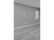 Minimalist living room featuring gray walls, tile floors, and natural light at 9239 Albus Hills Ave, Las Vegas, NV 89143