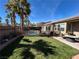 Private backyard featuring lush greenery, a pool, patio area and mature palm trees at 9361 Olympia Falls Ave, Las Vegas, NV 89149