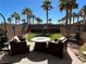 Backyard with a well-manicured lawn, seating area, and stone features at 9361 Olympia Falls Ave, Las Vegas, NV 89149