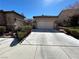Charming single-Gathering home with a well-maintained desert landscape and a long driveway at 9361 Olympia Falls Ave, Las Vegas, NV 89149