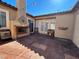 Stamped-concrete patio with outdoor fireplace, french doors, and unique decor at 9361 Olympia Falls Ave, Las Vegas, NV 89149