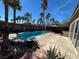 Inviting backyard pool surrounded by palm trees, complemented by ample patio space for outdoor entertaining at 9361 Olympia Falls Ave, Las Vegas, NV 89149