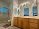 Bathroom featuring a glass shower, vanity with a sink, and an arrangement of decorative mirrors at , Las Vegas, NV 89134