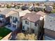 Backyard aerial of a two-story home featuring a patio, balcony, and lush landscaping at 10556 Nantucket Ridge Ave, Las Vegas, NV 89166