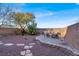 Well-maintained backyard featuring mature trees, decorative rock, and a seating area at 10556 Nantucket Ridge Ave, Las Vegas, NV 89166