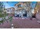 A backyard with desert landscaping, a block wall, and a view of the neighbor's property at 10556 Nantucket Ridge Ave, Las Vegas, NV 89166