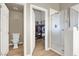 Bathroom featuring walk-in glass shower, toilet, and open doorway to the walk-in closet at 10556 Nantucket Ridge Ave, Las Vegas, NV 89166