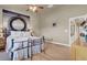 Bedroom with a ceiling fan and wooden floors, and view of a mirror and hallway at 10556 Nantucket Ridge Ave, Las Vegas, NV 89166