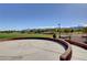 Well-maintained common area with a circular concrete pad, brick accents, and views of green space and mountains at 10556 Nantucket Ridge Ave, Las Vegas, NV 89166