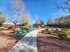 A beautiful and serene community park area with mature landscaping and benches at 10556 Nantucket Ridge Ave, Las Vegas, NV 89166