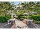 A beautiful stone path leads through a lush community garden with an arbor at 10556 Nantucket Ridge Ave, Las Vegas, NV 89166